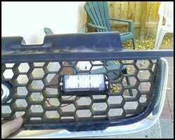 ai233.photobucket.com_albums_ee229_hawkspringsfire_Ford_20Escape_20Install_grille2.jpg